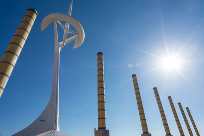 Low angle view of communications tower against clear blue sky