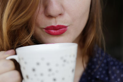 Close-up woman drinking coffee