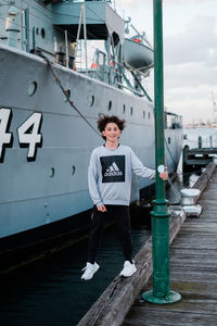 Portrait of young man standing on boat