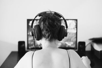 Rear view of woman listening to music