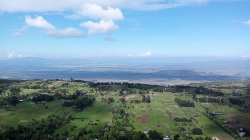 Aerial view of green landscape against sky