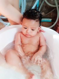 Shirtless baby boy in tub