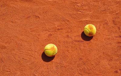 High angle view of tennis balls on sand