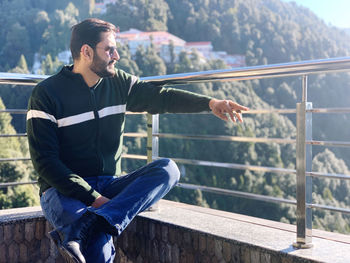 Side view of man sitting on staircase