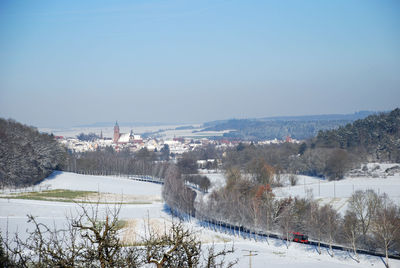 Scenic view of city against clear sky during winter