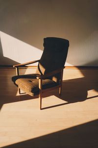 Empty chairs against wall at home