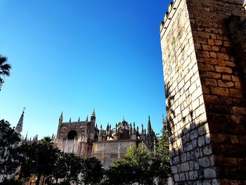 Low angle view of historic building against clear blue sky