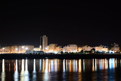 Illuminated city at waterfront