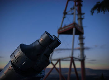 Close-up of binoculars against sky