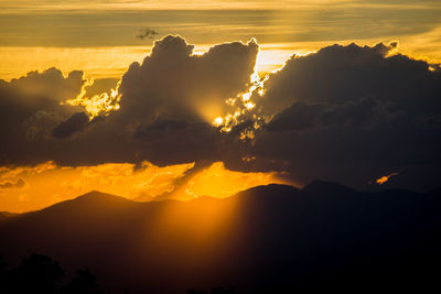 Scenic view of silhouette mountains against sky during sunset