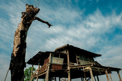 Low angle view of abandoned house against sky