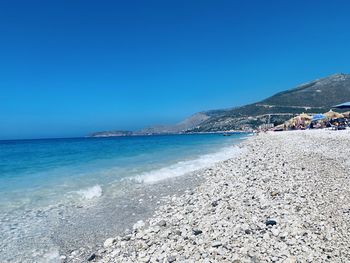 Scenic view of borsh sea against clear blue sky