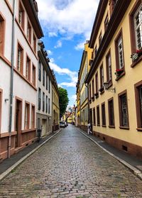 Street amidst buildings against sky