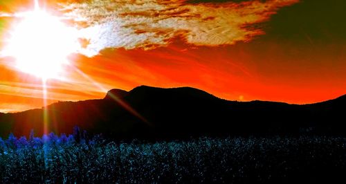 Silhouette landscape against scenic sky