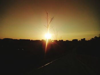 Silhouette landscape against sunset sky