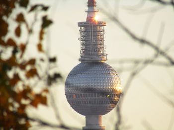Low angle view of illuminated electric light against building