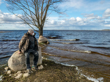 Full length of man on beach against sky