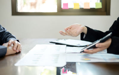 Midsection of business colleagues working at office