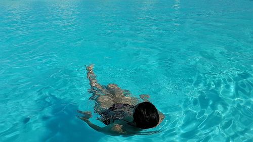 High angle view of woman swimming in sea