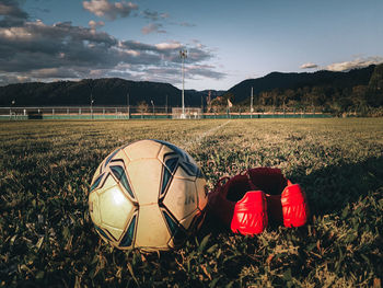 Soccer ball on field against sky