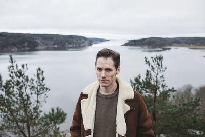 Man looking at camera, sea in background