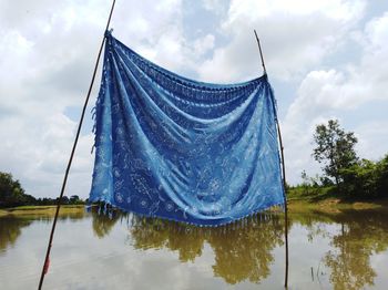 Panoramic view of flag on lake against sky