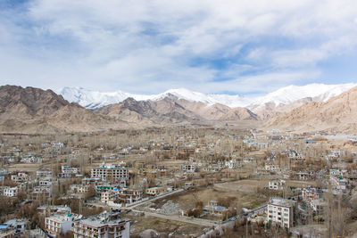 Aerial view of townscape with mountain in background