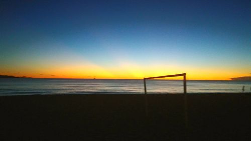 Scenic view of beach against sky during sunset