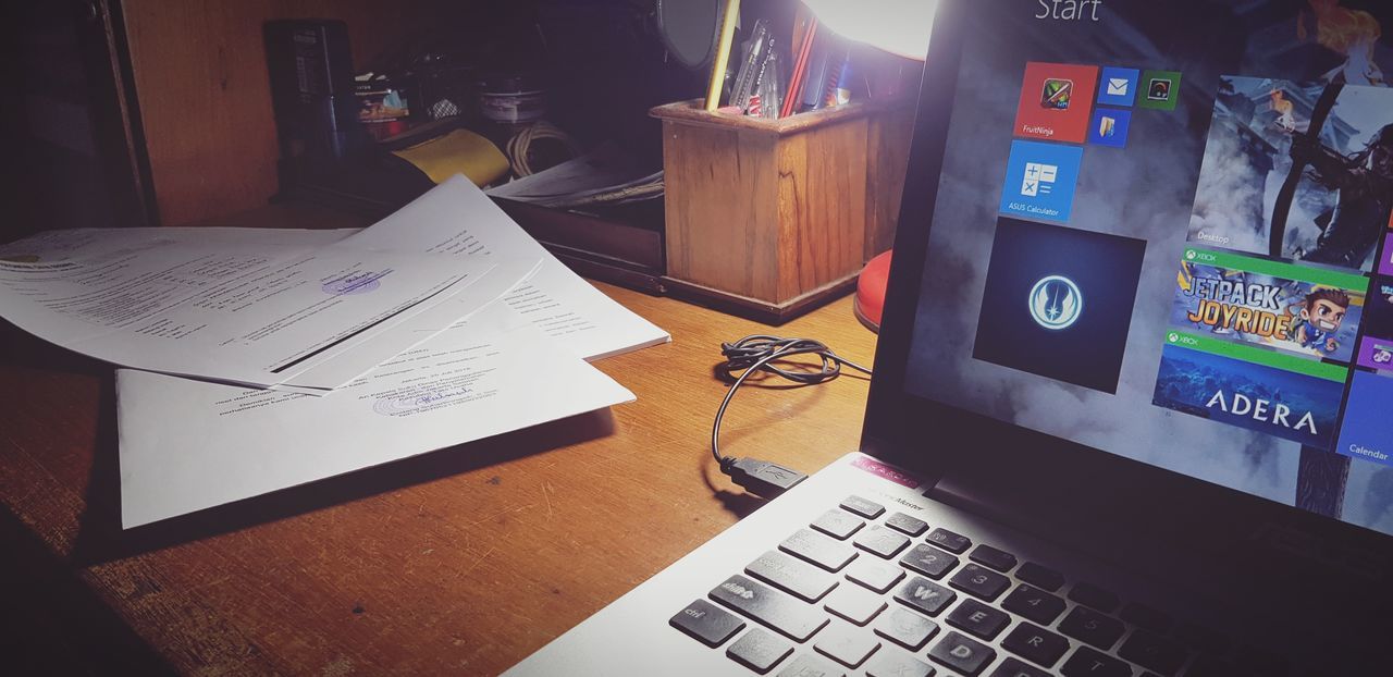 computer, wireless technology, table, technology, connection, communication, laptop, indoors, paper, furniture, no people, desk, computer equipment, high angle view, portable information device, still life, wood - material, book, keyboard, business, home office