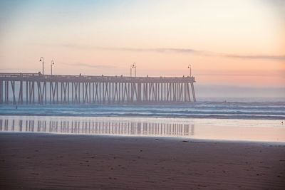 Scenic view of beach against sky during sunset