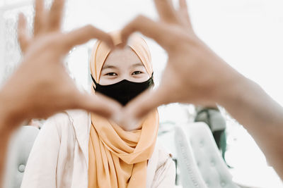 Love gesture to a woman in hijab