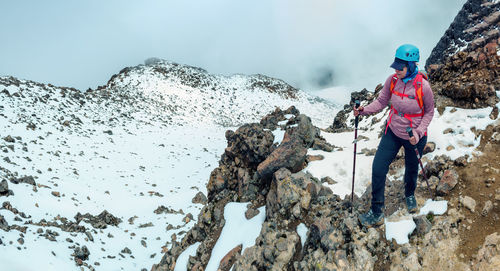 Rear view of man standing on rock