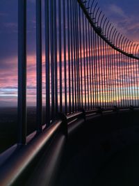 View of sky seen through window during sunset from the top of the a tower