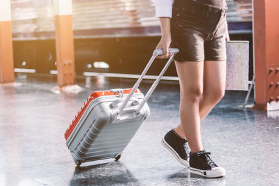 Low section of woman walking on floor