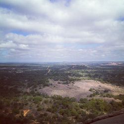 Scenic view of landscape against cloudy sky