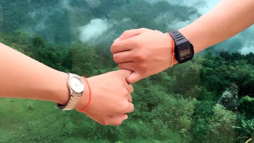 Midsection of couple holding hands