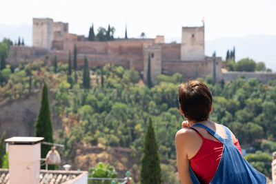 Rear view of woman looking at built castle