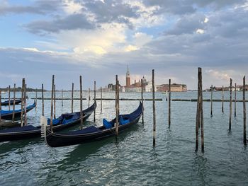 Gondolas in sea against sky