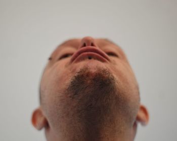 Close-up portrait of man against white background