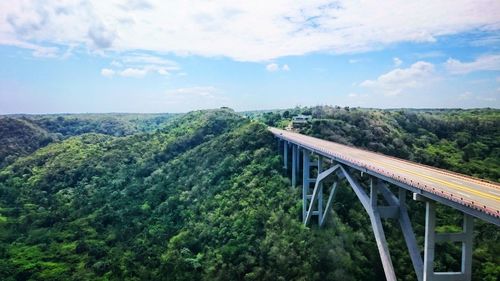 Bridge over river against cloudy sky