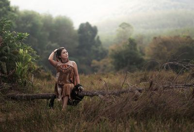 Young woman looking away on field