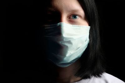 Girl in medical disposable mask looking at the camera.the concept of the epidemic coronavirus