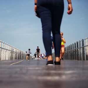 People walking on bridge in city