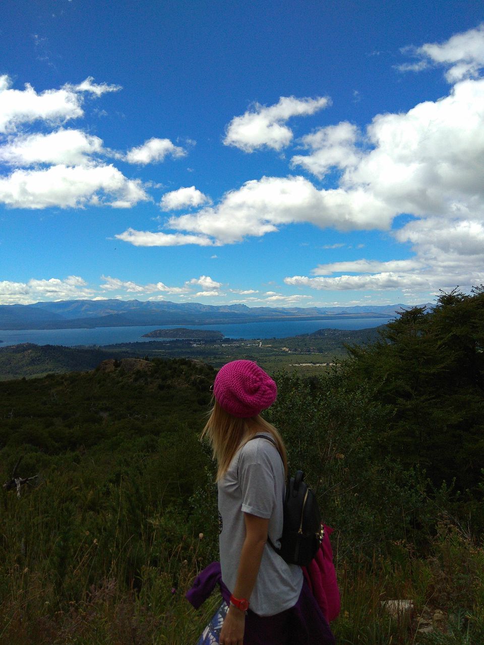 sky, real people, leisure activity, one person, lifestyles, rear view, cloud - sky, nature, mountain, standing, casual clothing, tranquility, beauty in nature, outdoors, scenics, day, landscape, women, full length, young women, young adult, people