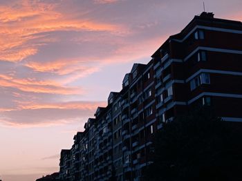 Low angle view of building against sky at sunset