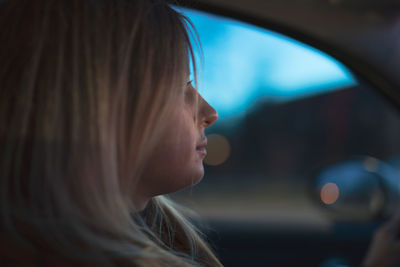 Close-up of young woman looking away