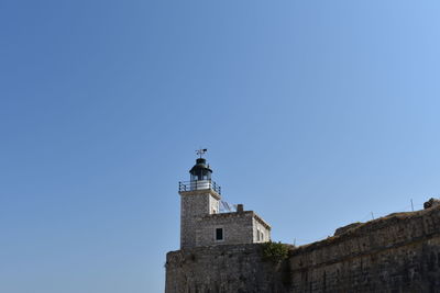 Low angle view of lighthouse against clear blue sky