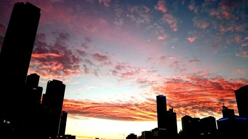 Silhouette of building against cloudy sky