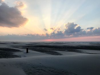 Scenic view of beach against sky during sunset