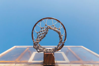 Low angle view of basketball hoop against blue sky